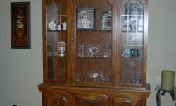 Beautiful oak china hutch with lighted cabinet. Excellent condition. MUST SELL! Moving Sept. 1st and can't take it with. Dimensions: 77H x 54W x 16W Will entertain all offers.