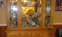 Beautiful oak china hutch-great addition to your formal or informal dining space. Great storage. The top section is lighted with 3 beveled doors that open so you can store your collectibles. The bottom portion has 3 solid doors and 4 drawers all for extra