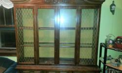 Walnut china hutch....good condition...glass shelves, glass doors...storage in bottom
Two pieces...easy to move...has light inside