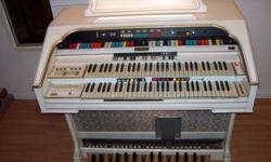 White w/ Pearl Trim, Two rows of keys, buttons which create special background effects, pedals and bench seat included. Plays very well.
We must part ways with this organ, it has been like part of the family. Hopefully, someone who is musically inclined