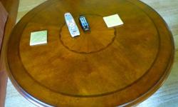 Round coffee table, walnut color, inlaid design. &nbsp;With iron casters, 4 drawers. &nbsp;Excellent shape. &nbsp;40" in diameter, 19.5" high.