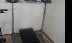 Compact Leg Press Machine with 100lbs of weights. Only one year old and slightly used. Great condition and utilizes small area of space