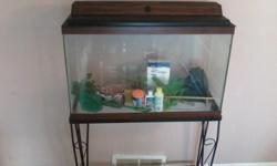 We are selling a complete 30 Gallon fish aquarium with iron stand, Gravel, 2 fish nets, filter and filter carts.decorations (plants and ceramic log), food, algaecide, cleaning tools, and water conditioner. Asking $75.00 This is used but in great shape if