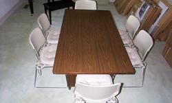 Heavy duty conference table with six chairs. Ideal for use in office or home. Sturdy chairs are stackable for storage and have padded seats and steel chrome frame. Table has large center drawer and Formica top. Table measures 34" wide by 66" long. All in