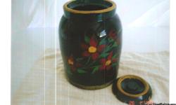 Cookie jar crock with lid and floral design over black base color.