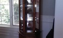 Moving sale. Curio cabinet is in exellent condition. Glass shelves. Medium oak stained finish.