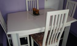 I have a white lacquered finish dining room table with 4 matching chairs for sale. The table measures 52 inches long by 30 1/4 inches wide. It has an extension which measures 30 1/4 inches. The top part on the back rests of 2 chairs need a little touch up