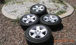Four wheels with tires for dodge/Chrysler car or station wagon. P215/65R 17. Used but showing no wear. Not for Durango or full sized vans. Dodge emblem on light weigth wheels. Will trade for hand gun or rifle.