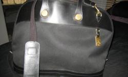 Only used a few times. In excellent condition. Do not use it enough to keep it.
Dooney & Bourke Cabriolet Overnight Bag w/ Leather Trim - BLACK w/Black trim
Generate an air of stylish sophistication when you travel with this magnificent overnight bag.