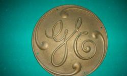 Solid brass emblem from a GE steam Turbine. Weght is 9.4 lbs, 12inch in dia. 3/8 thick