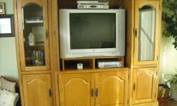 Three piece entertainment center in excellent condition. Measures 84" in width, 26" deep and 38" of space for TV. Has many shelves for components. Below the TV are two cupboards with two shelves in each. The two side pieces have glass doors and two