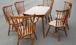 Well kept Dining Room / Kitchen Set with table that has a drop leaf on both sides plus two leaf extensions. Six chairs are included with two of them being Captain Chairs. "Ethan Allen Quality"