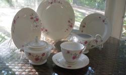 Fine porcelain china dinner set, with a delicate Victoriana Rose design in pink and grey. Eight settings, each with a dinner plate, soup bowl, salad plate, teacup and saucer. Serving pieces include a platter, serving bowl, creamer, and sugar bowl. The
