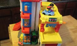 This is a Fisher Price Little people Garage. It has electrical Sounds and an Elevator for cars and people to go up and down. It is missing a flap on the road way and some wear to the stickers but these are Very hard to Find.... It has two cars and two