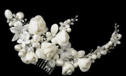A beautiful floral hair comb that features ivory and embroidery flower rhinestones in leaf design and pearls accents. This magnificent hair piece is lovely and radiant, a dashing accessory piece that is perfect for your spring/summer theme wedding.