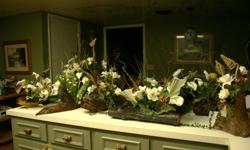 These flower arrangements I made for a wedding.The flowers are in lighterwood pieces of wood.I can make you anykind of flower arrangements you need.