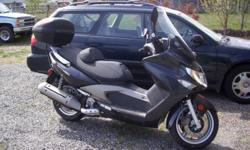 BLACK AND SILVER SCOOTER WITH FARING AND HARD CASE CARRIER. VERY SHARP LOOKING. LOW MILEAGE AND ECONOMICAL. YOUR SUMMER TRAVELS WILL BE SOMETHING TO REMEMBER.