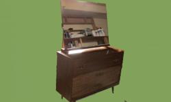 I have a bedroom dresser with mirror. It has three, fairly deep, long drawers and is a wood finish. It is in good shape except for a small cigarette burn on the top, which is easily covered with an ornament.