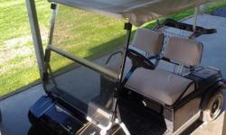 92 electric club car golf cart. Black. Needs new paint. Has good tires weather top and windshield. Will come with battery charger.