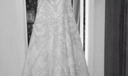 Gorgeous Casablanca wedding gown worn three hours purchased January 2013. Perfect combination of elegance and originality with breathtaking form that defines the waist while also creating a figure flattering look. Brief description: A-line silhouette with