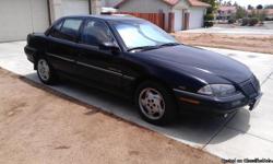 1995 Black Pontiac GRAND-AM (SE)
With a 3.100 Engine V-6
Has a Full Tank of Gas
154,000 Miles
26-Miles Per Gallon
Remote Keyless Entry and Alarm System by GM Good wrench
4-Doors
Dash Cover
AM/FM Cassette Stereo
Tilt Steering Wheel
Cruise Control
Fog