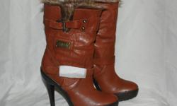Womens Brown highheel boots leather upper with foux fur lining size 7.
Brand new, never worn.