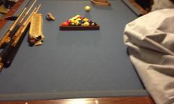 American Heritage wooden pool table with blue felt. Comes with sticks, extra tips( that goes on the sticks, brushes, the works!!!! We need this gone due to an expanding family. We hardly ever use it maybe 1 time a year. This is a great buy actual retail