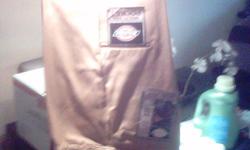 Liquidating my storage to save some dough! This pair of very nice, brand new (still have the tags on them), never before worn, size 33 x 32 tan colored, loose fit, easy care, double knee dickie work pant with cell phone pocket and scotch guard stain