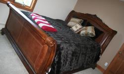 KING SIZE BEDROOM SET WITH LEATHER ON THE FOOT AND HEAD BOARD. OUTLINED IN BRONZE BULLETS. HAS A MALE DRESSER, FEMALE DRESSER WITH MIRROR, AND TWO END TABLES. GOOD CONDITION