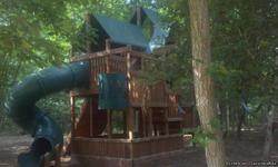Sadly outgrown. Three story, cedar with green vinyl roofs, super slide, rock climbing wall, 3 belt swings, knotted pine rope swing with disc, crow's nest, bubble panel, etc. Beautiful set. Paid $11,000 new from Ultimate Backyard.