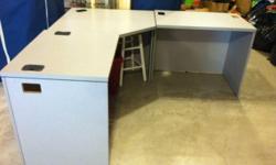 Large L shaped desk with 3 separate units... Gray wood
Center section is 36" wide, each of the end units is 28" wide.
Could use parts separately or in different configuration
Has cut out for cords.
If you need lots of work surface, This unit would meet