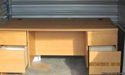 LARGE OFFICE DESK
51" LONG
30" WIDE
29" TALL
4 DRAWERS, SOME WITH EDGES FOR HANGING FILES
&nbsp;HOLES FOR WIRES&nbsp;ON EACH END
BLONDE IN COLOR