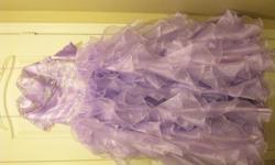 I am selling my daughter's beautiful quinceanera or sweet 16 dress was used for a few hours.&nbsp; It's in excellent condition.&nbsp; The dress is ruffled, strapless in lavender color with silver accents, beads and flowers, lace up back and corset