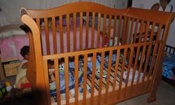 light oak converter baby crib turns into day bed or full size bed. practically brand new bought from a baby boutique