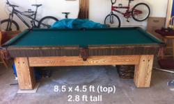 Great condition solid wood pool table with a solid marble top, cues, balls, triangle and cover included. Dimensions are as follows: top 8.5 x 4.5 ft, height 2.8 ft.