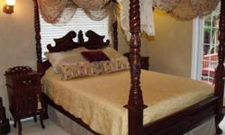 Beautiful complete (Indonesian Mahogany) Bedroom set! Includes: Queen Sized Canopy Bed with carved headboard, footboard & side rails. 2 matching night stands (with storage).