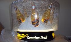 THIS MILLER GENUINE DRAFT SNOW GLOBE HAS A LIGHT AND MOVES FAKE SNOW ALL INSIDE THE DOME.YOU CAN HANG IT JUST ABOUT ANY WHERE YOU LIKE.MILLER ONLY MADE THREE TYPES A SMALL ONE THEN A HANGING ONE AND A FLOOR MODEL AND THEY DO NOT MAKE THEM ANY MORE.THIS
