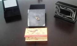 These 4 distinctive jewelry boxes are all in very good condition. Varying in materials and features; they come in various brands, shapes, colors, sizes and designs. Can be used for many different purposes. At a great price, they shouldn't be passed up. If