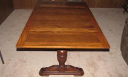 MONKS DROP LEAF OAK TABLE. CIRCA 1920'S-30'S. TABLE HAS DOUBLE PEDESTAL BASE W/WOOD STRETCHER. 3'x 3' square. WHEN SIDES OF TABLE A PULLED OUT, TABLE CONVERTS TO A 3'x 6' DINING/PRAYER TABLE