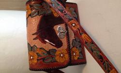 Wild rose patern brown with yellow flowers and off green leaves 4 different horses with matching rose pattern on shoulder strap 7 pocket insert bag with one zippered pouch and a draw string and 2 key chain holders its 8" tall 9 1/2" long and 3" to 5" wide