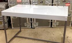 A metal Nike branded display table, It measures approximately 54"W x 31"D x 34.25"T. It is used but in good condition. Item: 12202