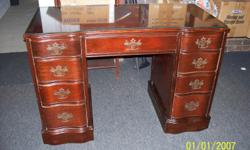 Nice old knee holed desk Dewsk is solid mahogany with dove tail drawers. Desk from 1940' - 1950's . Desk has glass top.