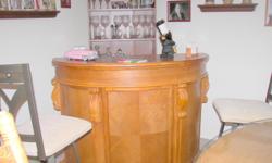This is a beautiful oak bar that has hardly been used [maybe twice]. It comes with a variety of games such as roulette, 21 and other games under the removal/reversible bar top. This is a heavy piece of furniture.
The bar stands approximately 43 inches in