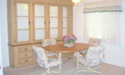 42" by 56" oak dining room set with 4 rolling chairs. Excellent condition.