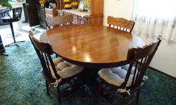 Oak dining room table and six (6) pressed back chairs with seat pads. Table is 44 x 55 oval including one (1) leaf. Claw foot pedestal base. CASH ONLY PLEASE!