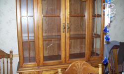 Dining room set. Table which includes 2 leaves,4 regular and 2 captain&nbsp;chairs. Solid oak with matching&nbsp; 2 piece oak hutch. Hutch has&nbsp;beautiful glass shelves and doors.&nbsp; Excellent condition.