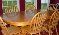 Solid oak dining set with 6 chairs. Round table measures 60" wide. Two leaves included that measure 18 inches each. Oval table with 1 leaf measures 78" and 96" with 2 leaves. Leaves store underneath the table. There is a chain mechanism for opening and