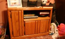 Oak t.v. stand very good condition size is as follows, 20" deep X 33" long X 25" high.