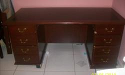 Cherry wood office desk. Four drawers on left side and four drawers on right side.