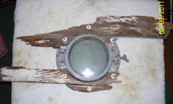 old porthole with wood still attached, great item for nautical decorating. local pick up.